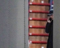 Woman dressed all in black speaking on the phone