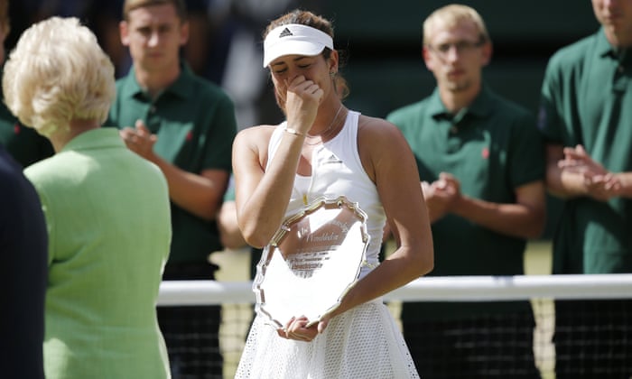 Muguruza breaks down as she holds her runners up plate after losing