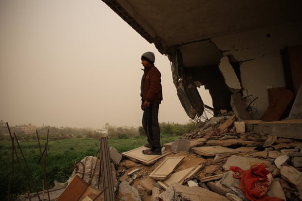 Sabeha’s grandson, Hareth stands on the hill of a rubble where his room once was