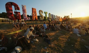 Festival goers enjoying the sun at Glastonbury.