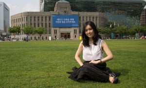 Hyeonseo Lee poses sitting on grass at the Seoul Plaza in front of City Hall in central Seoul June 19, 2015