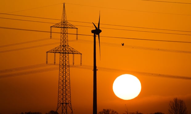 A wind turbine and electricity pylon