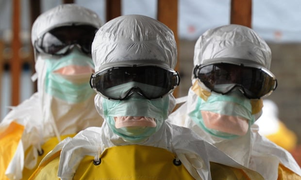 Aid workers in biohazard suits