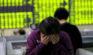 An investor covers her face in a stock exchange hall in Nantong, Jiangsu province, China, during the recent week of turbulence.