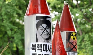 Pictures of North Korean leader Kim Jong-un as a boy and his father, Kim Jong-il, on mock missiles during a Seoul protest in 2009.