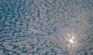 The sun glints off melting sea ice near Ellesmere Island.