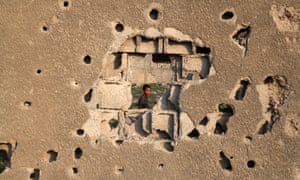 Bullet and shell holes on a house in Gaza. Three-quarters of Gaza’s children experience unusual bedwetting regularly, and nine in 10 report constant feelings of fear, says a Save the Children report.