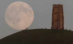The moon rises over people gathered on Glastonbury Tor, Somerset, England on July 30, 2015. Tonight it will happen again and be called a Blue Moon. The last time this happened was in 2012 and there isn't due another until 2018.
