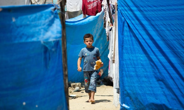 A young Syrian refugee eats bread at a camp in Adana, Turkey. He is on of 4,013,000 Syrian people who have fled to neighbouring countries since the Syria conflict started five years ago.