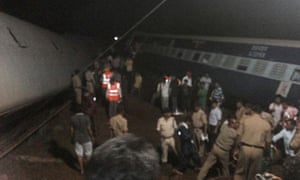 People in between derailed carriages soon after the crash.