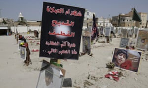 Religious flags, photographs and tributes to the victims of a suicide bombing in Saudi Arabia in May.
