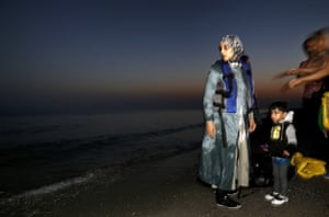 Syrian refugees moments after arriving in a dinghy at the Greek island of Kos having crossed part of the Aegean sea between Turkey and Greece