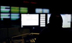 A cybersecurity expert monitors telecommunications traffic at a network operations center in a Verizon facility in Ashburn, Virginia.