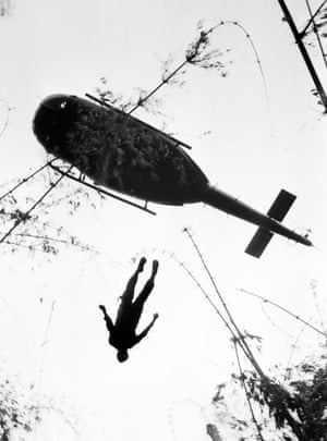 The body of a US paratrooper killed in action in the jungle near the Cambodian border is lifted up to an evacuation helicopter in War Zone C, May 14, 1966
