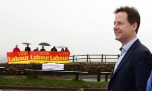 Nick Clegg arrives to unveil a Liberal Democrat election poster in Hyde, Cheshire, as Labour supporters stage a counter rally.