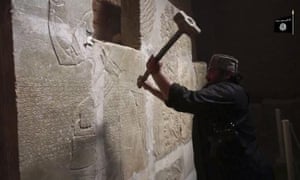Islamic State militant taking taking a sledgehammer to an Assyrian relief at the site of the ancient Assyrian city of Nimrud