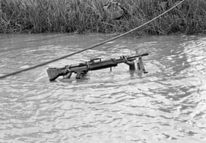 A six-foot-five machine gunner with the U.S. 9th Infantry Division is submerged except for his rifle as he crosses a muddy stream in the Mekong Delta south of Saigon, September 10, 1968