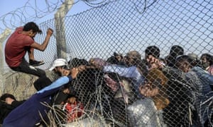 Syrians fleeing through broken fences to enter Turkish territory at Akcakale border crossing on 14 June 2015.
