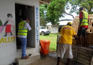 Red Cross personnel handling donated food to use as relief from Cyclone Pam, in the Vanuatu capital of Port Vila.