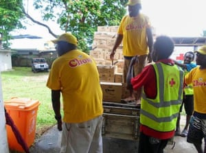 Red Cross personnel handling donated food to use as relief from Cyclone Pam, in the Vanuatu capital of Port Vila.