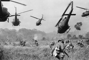 Hovering US Army helicopters pour machine-gun fire into the tree line to cover the advance of South Vietnamese ground troops as they attack a Vietcong camp 18 miles north of Tay Ninh, near the Cambodian border, in March 1965