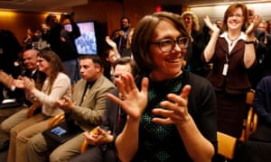 Members of the audience react after the Federal Communications Commission votes to pass the new rules.