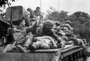 Marines transport their seriously wounded atop a US Army tank through the streets of Hue toward a helicopter evacuation point, February 17, 1968