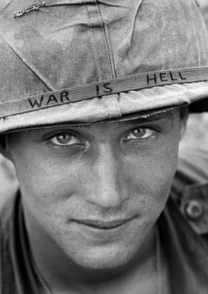 An unidentified American soldier wears a hand-lettered slogan on his helmet, June 1965. The soldier was serving with the 173rd Airborne Brigade on defense duty at the Phuoc Vinh airfield