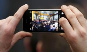 Ed Miliband seen through a phone camera at a visit to an engineering company in Huddersfield
