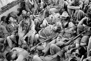 Exhausted South Vietnamese soldiers sleep on a US Navy troop carrier taking them back to the provincial capital of Ca Mau, August 1962. The infantry unit had been on a four-day operation against the Viet Cong in swamplands at the southern tip of the country
