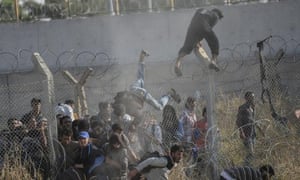Syrians fleeing the war cross broken border fences to enter Turkish territory illegally.