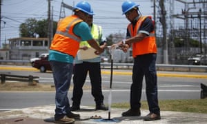 Puerto Rico Water Authority workers close a valve that supplies most of the metropolitan area with water in Carolina, Puerto Rico.
