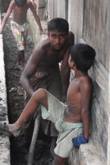 The youngest members of the Rohingya community clear out the storm ditches.