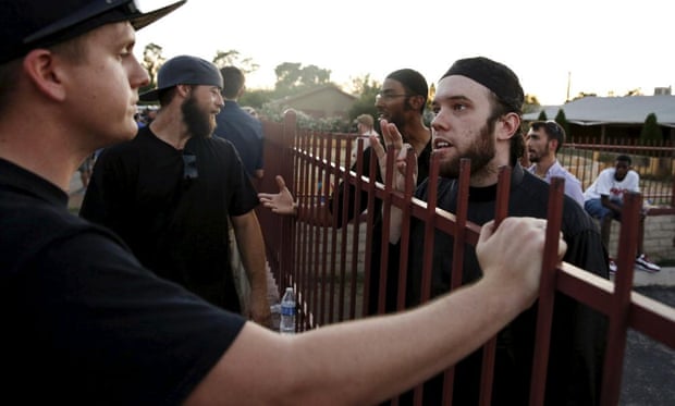 Members of the Islamic Community Center, including Ilyas Wadood (right), talk with people attending the ‘Freedom of Speech Rally Round II’ outside the center in Phoenix, Arizona.