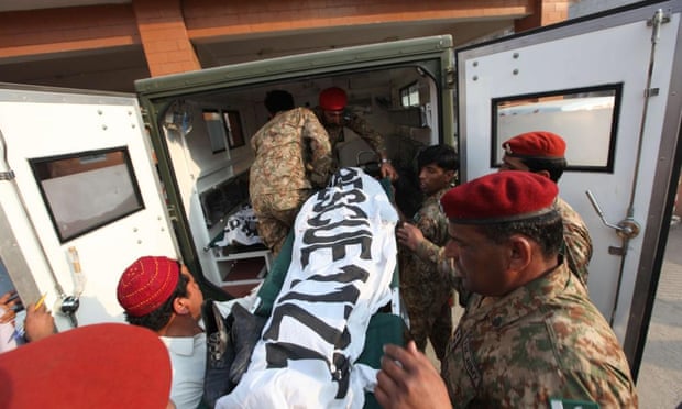 Pakistani soldiers moving bodies