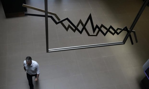 A man walks in the reception of the stock exchange in Athens.