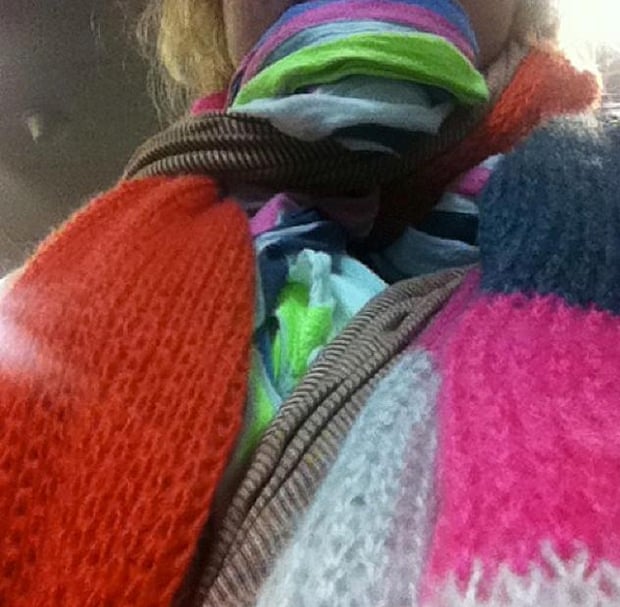 Brigid Delaney wearing several scarves from her carry-on luggage before boarding a Tigerair flight at an airport in Melbourne, Australia, in 2014. Delaney wore the scarves to reduce the weight of her carry-on luggage and thereby avoid a $200 luggage fee.