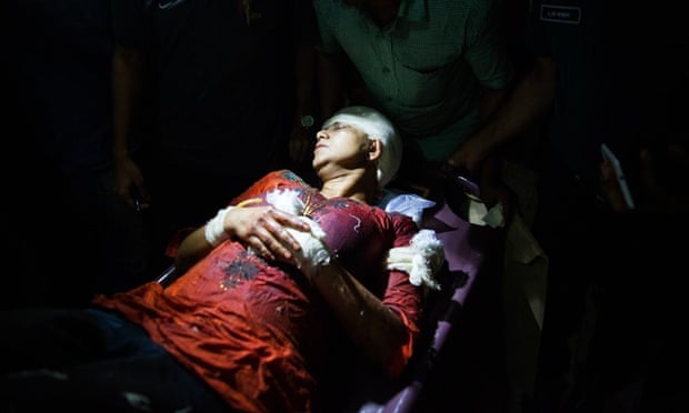 Avijit Roy’s wife Rafida Ahmed Banna is carried on a stretcher after she was seriously injured by unidentified assailants. Roy, founded a blog site which champions liberal secular writing in the Muslim majority nation.