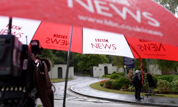 A BBC umbrella covers a TV camera outside the Berkshire estate where Sir Cliff Richard has an apartment.
