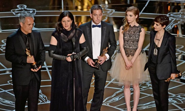 Laura Poitras, second left, accepts her award for Citizenfour.