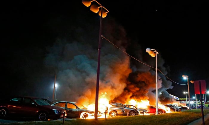 Cars burn at a car dealership in Ferguson, Missouri