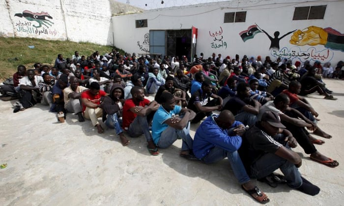 Illegal migrants sit in Abu Saleem detention centre in Tripoli. 