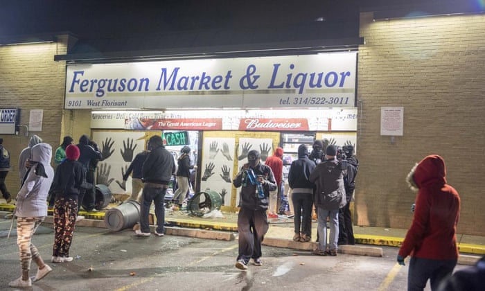 Looters run out of a store in Ferguson