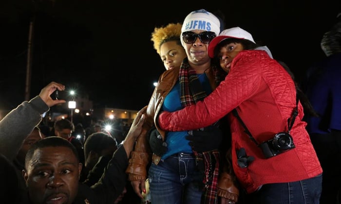 Lesley McSpadden, second from right, Michael Brown’s mother, is comforted outside the Ferguson police department