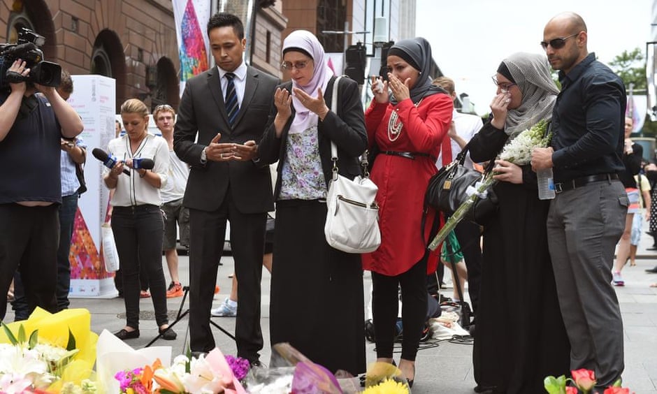 Muslims pray after laying flowers in Martin Place