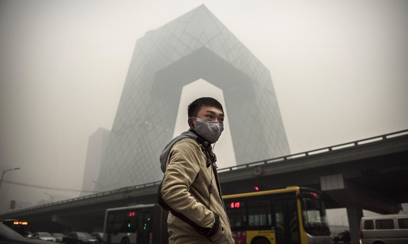 A Chinese man wears an anti-pollution mask near the China Central Television building in Beijing.