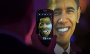 A man takes a photo of a life-size cutout of President Barack Obama at an election party at the US embassy in Berlin.
