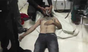 Amateur video provided by the Shams News Network, a loosely organized anti-Assad group, showing a man with an oxygen mask in Kfar Zeita, purportedly the site of a chemical attack.