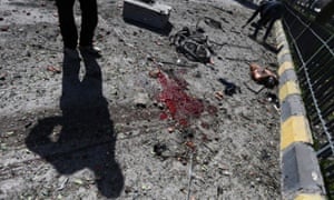 A man stands next to a blood stain in Damascus