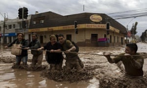 Chilean national police help evacuate people affected by the overflow of the river Copiapo in the city of the same name.